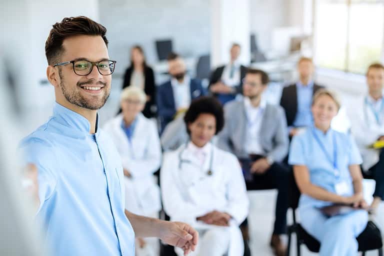 Professional man leading a seminar at a healthcare convention.
