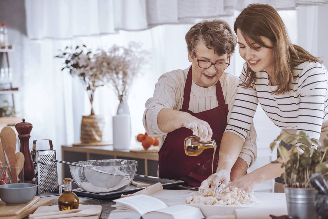 Living with gastroparesis, in the kitchen, grandmother and her granddaughter cooking together.