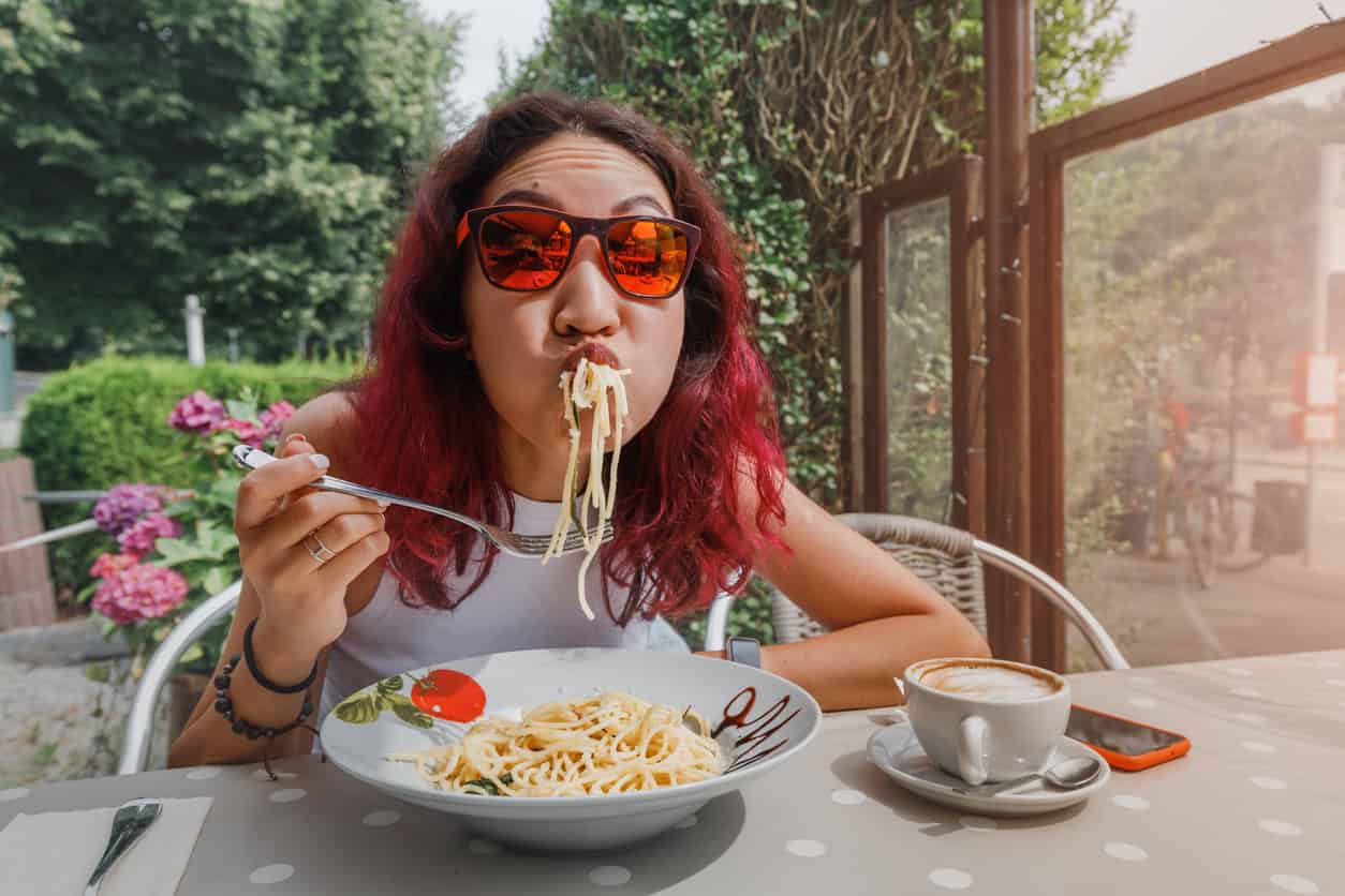 Living with gastroparesis and battling each bite. Photo of woman eating a bowl of pasta.