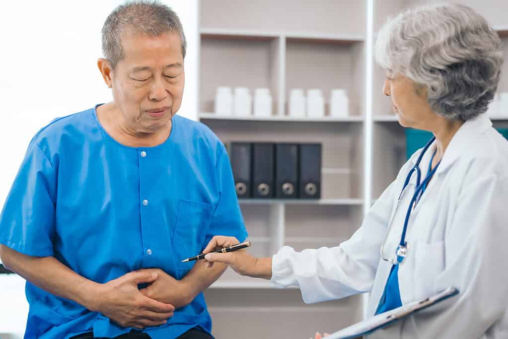 Senior elderly male patient and asian people mature woman doctor